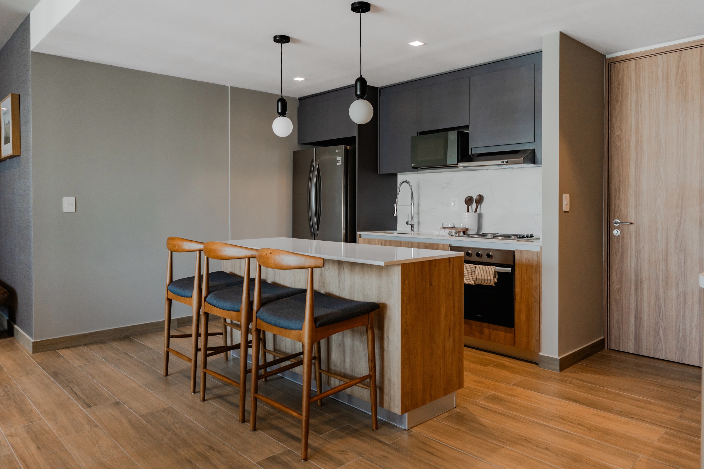 Depa muestra LUCA — cocina y barra con vista a la torre